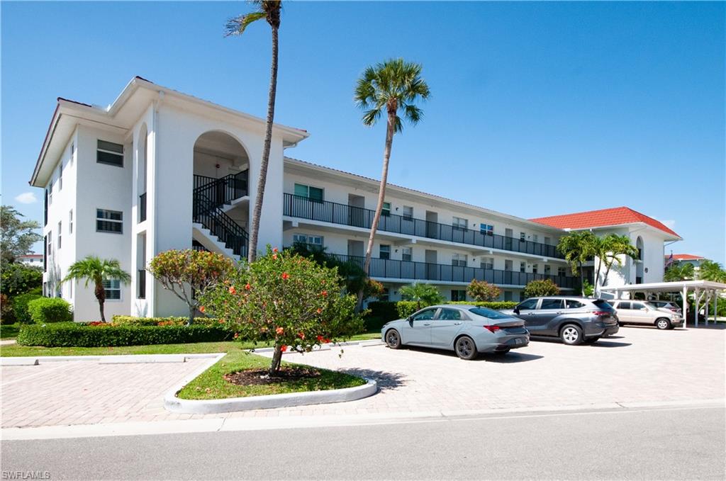 49 High Point Circle South, Unit 102 Naples, FL 34103 - Photo 11 of 42 One covered parking space, ample guest parking.