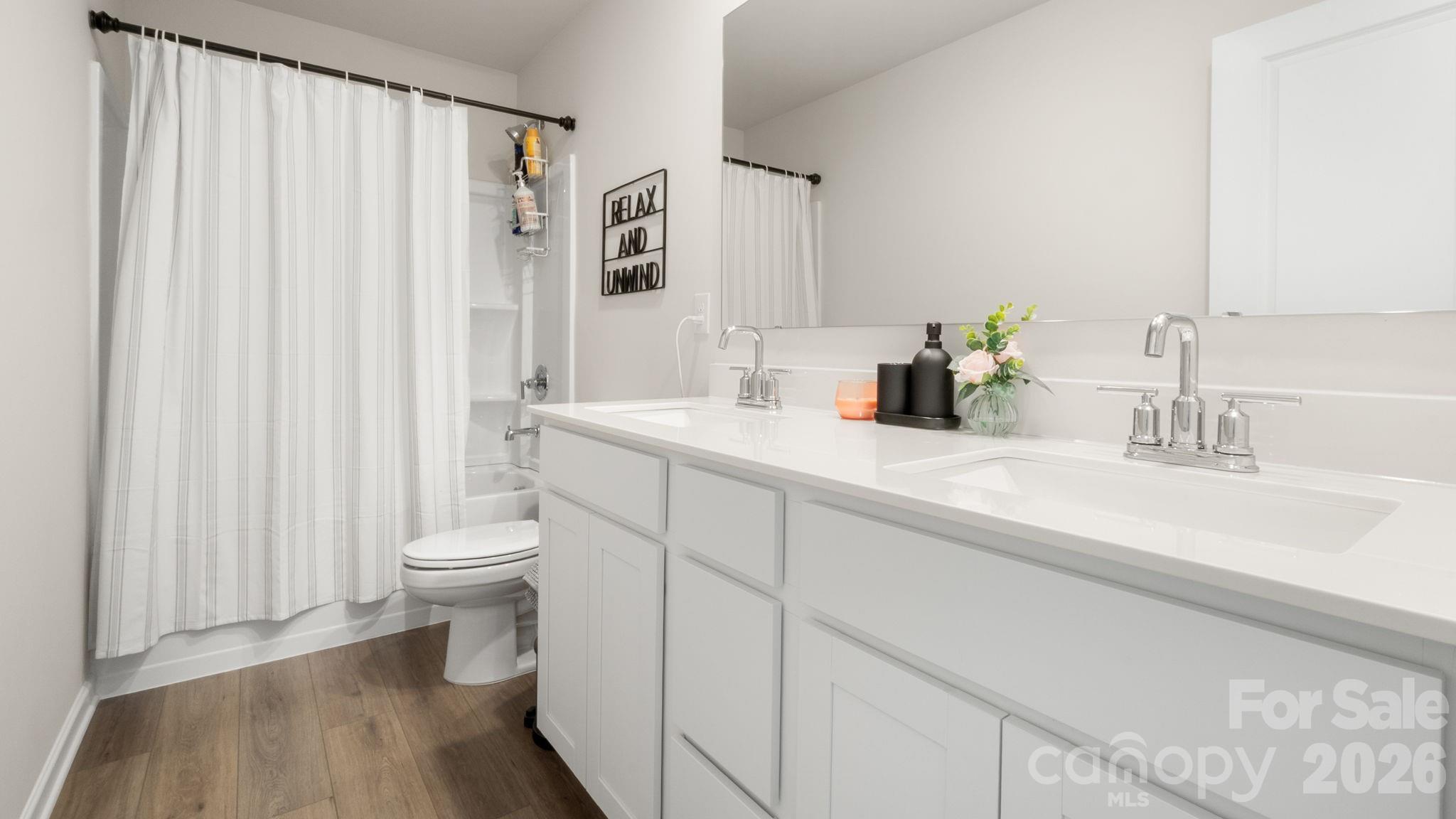 1615 Spring Edgemoor Sc 29712 Edgemoor, SC 29712 - Photo 23 of 30 a bathroom with a sink a toilet and shower curtain