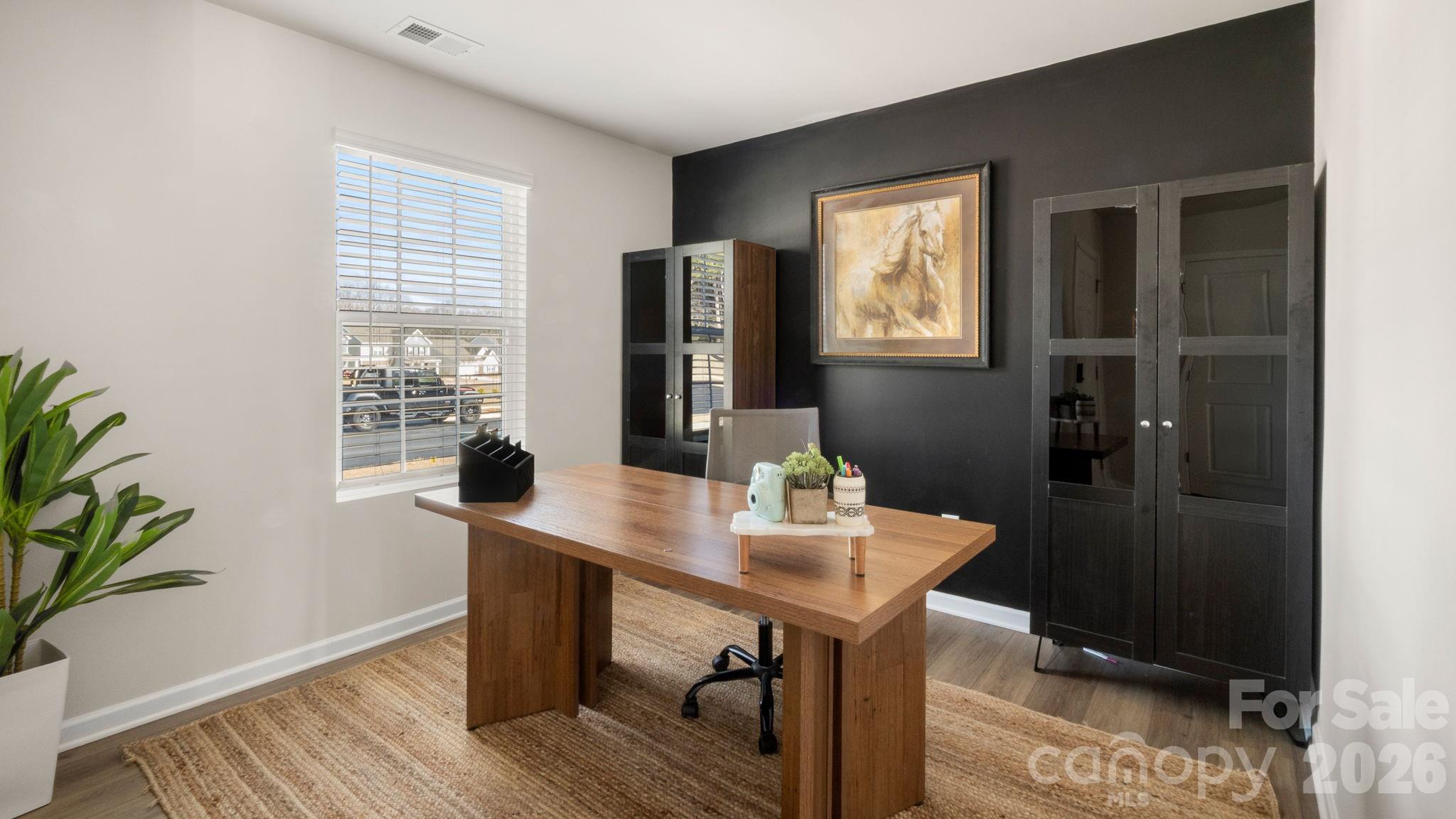 1615 Spring Edgemoor Sc 29712 Edgemoor, SC 29712 - Photo 5 of 30 a view of a workspace room with wooden floor and windows