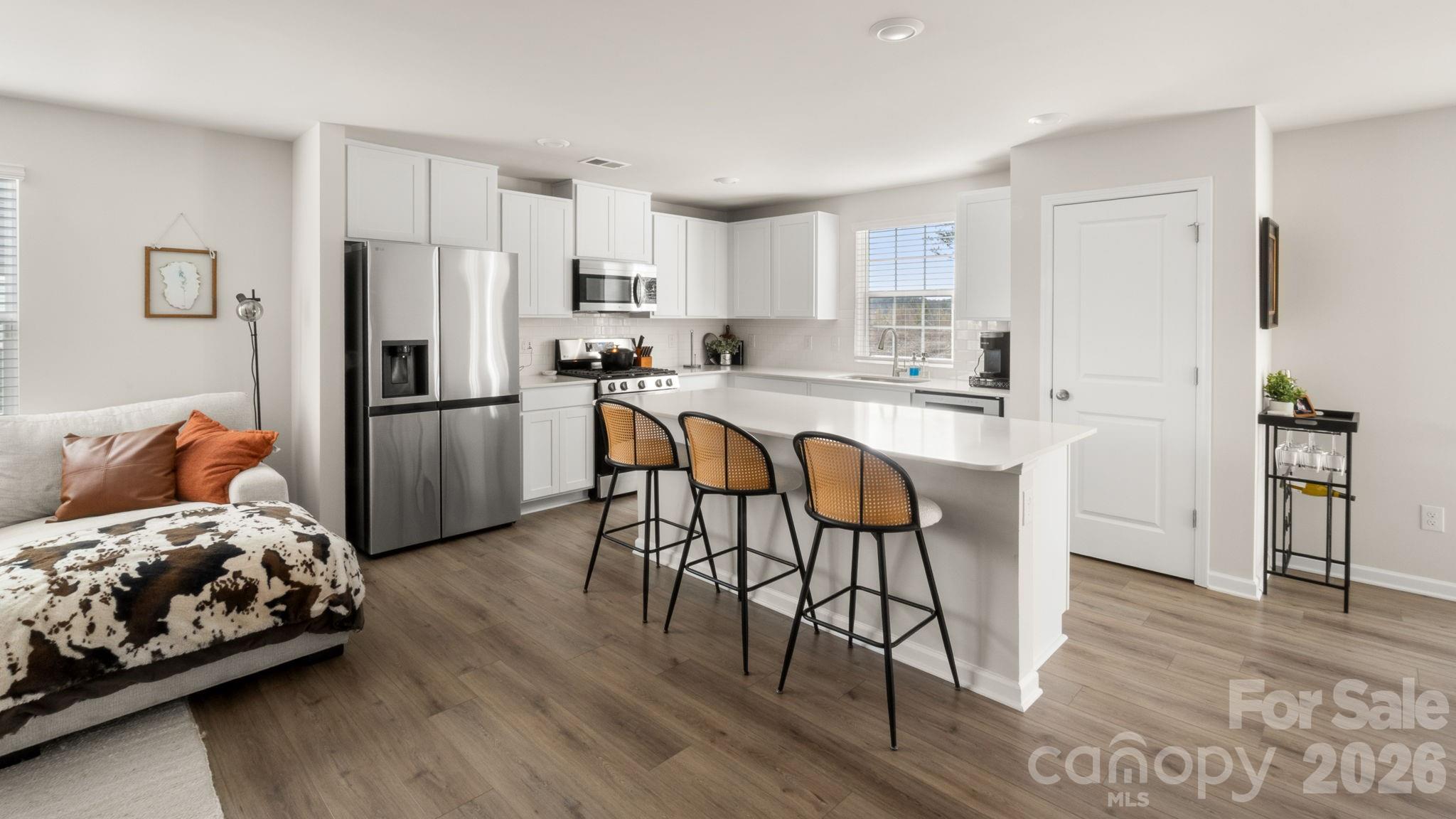 1615 Spring Edgemoor Sc 29712 Edgemoor, SC 29712 - Photo 9 of 30 a kitchen with stainless steel appliances a refrigerator a stove a sink dishwasher and a dining table with wooden floor