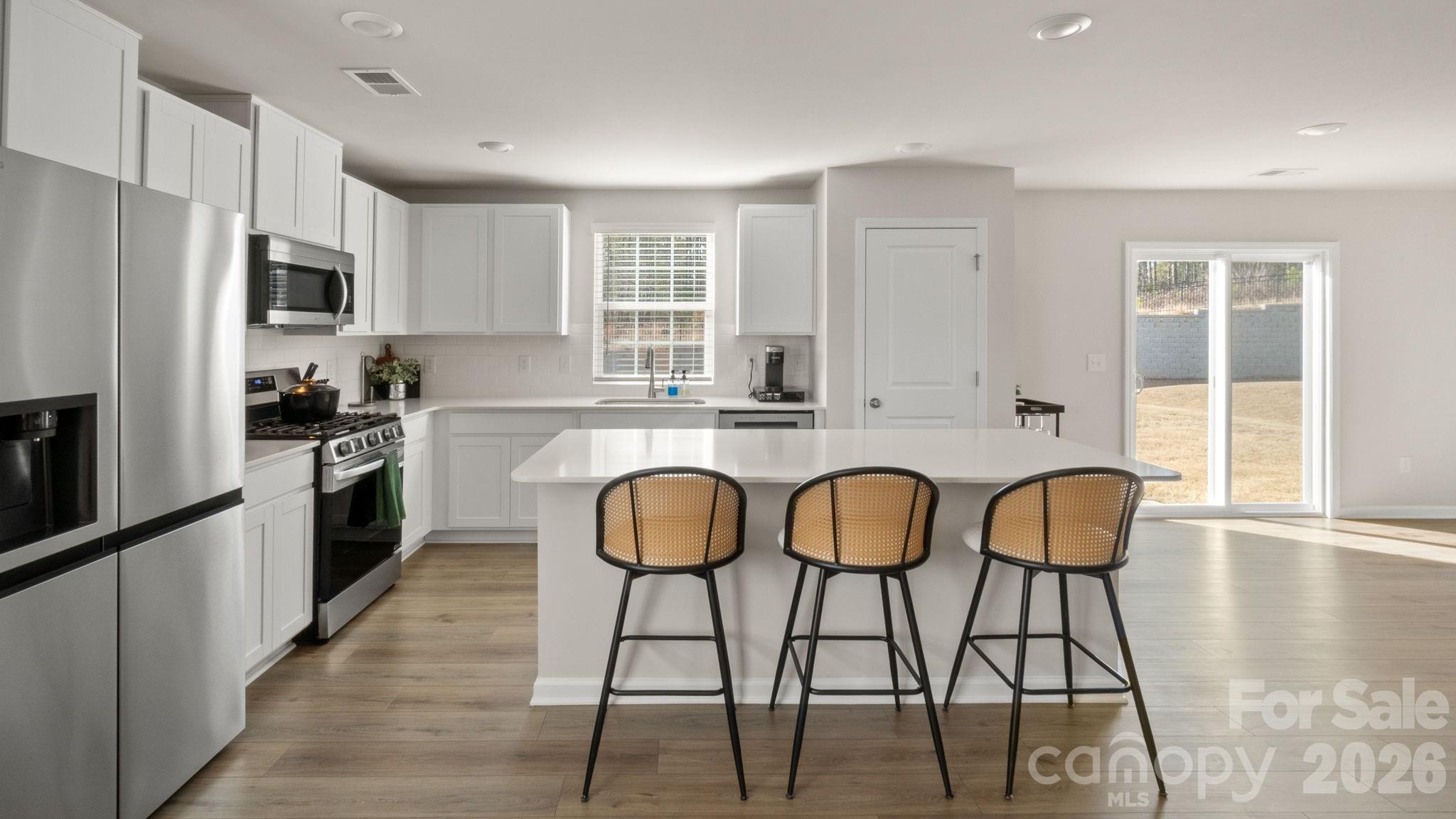1615 Spring Edgemoor Sc 29712 Edgemoor, SC 29712 - Photo 10 of 30 a kitchen with stainless steel appliances granite countertop a dining table chairs refrigerator and sink