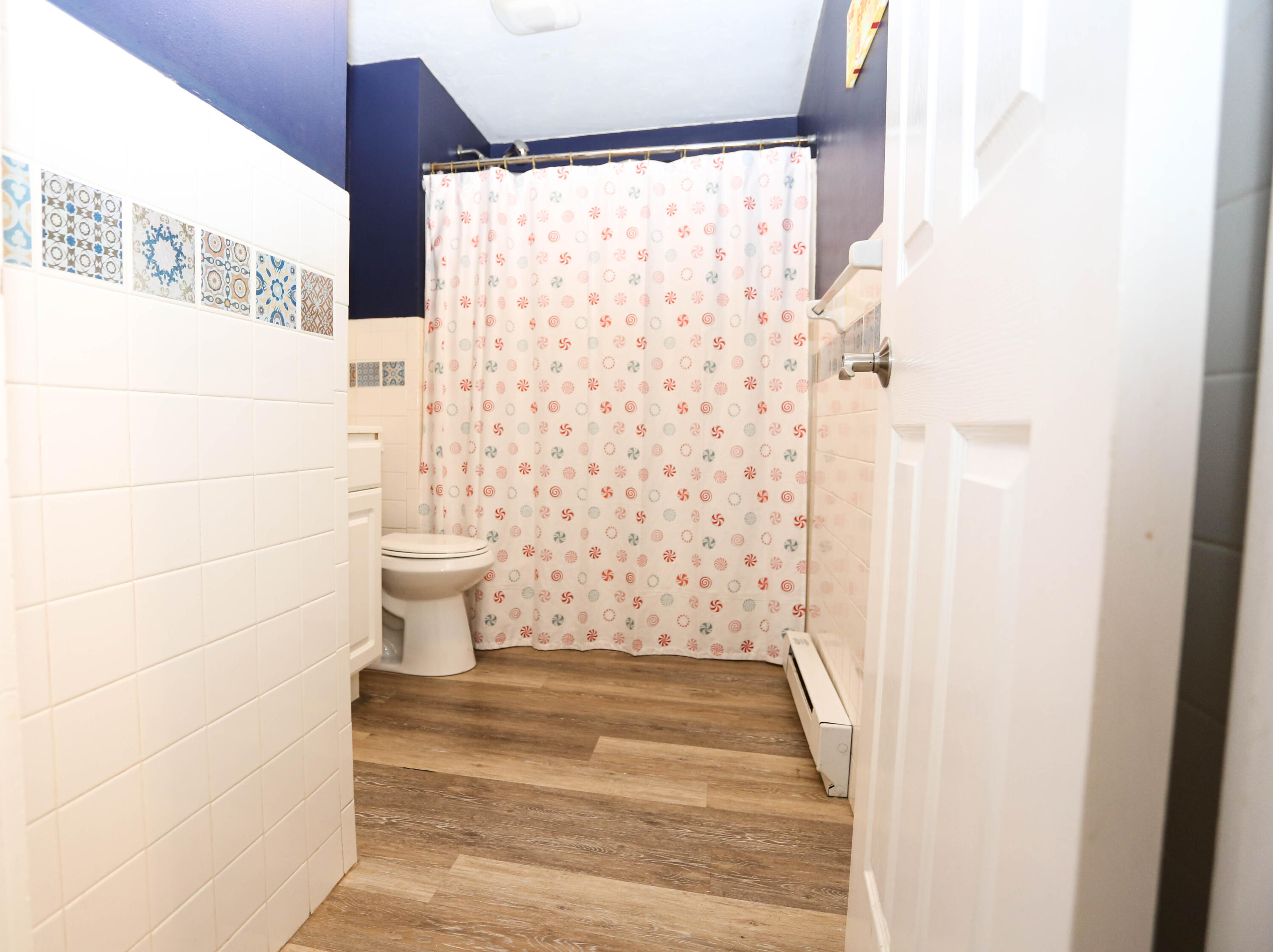 300 Falmouth Road, Unit 2C Mashpee, MA 02649 - Photo 11 of 17 a bathroom with a toilet and a shower curtain