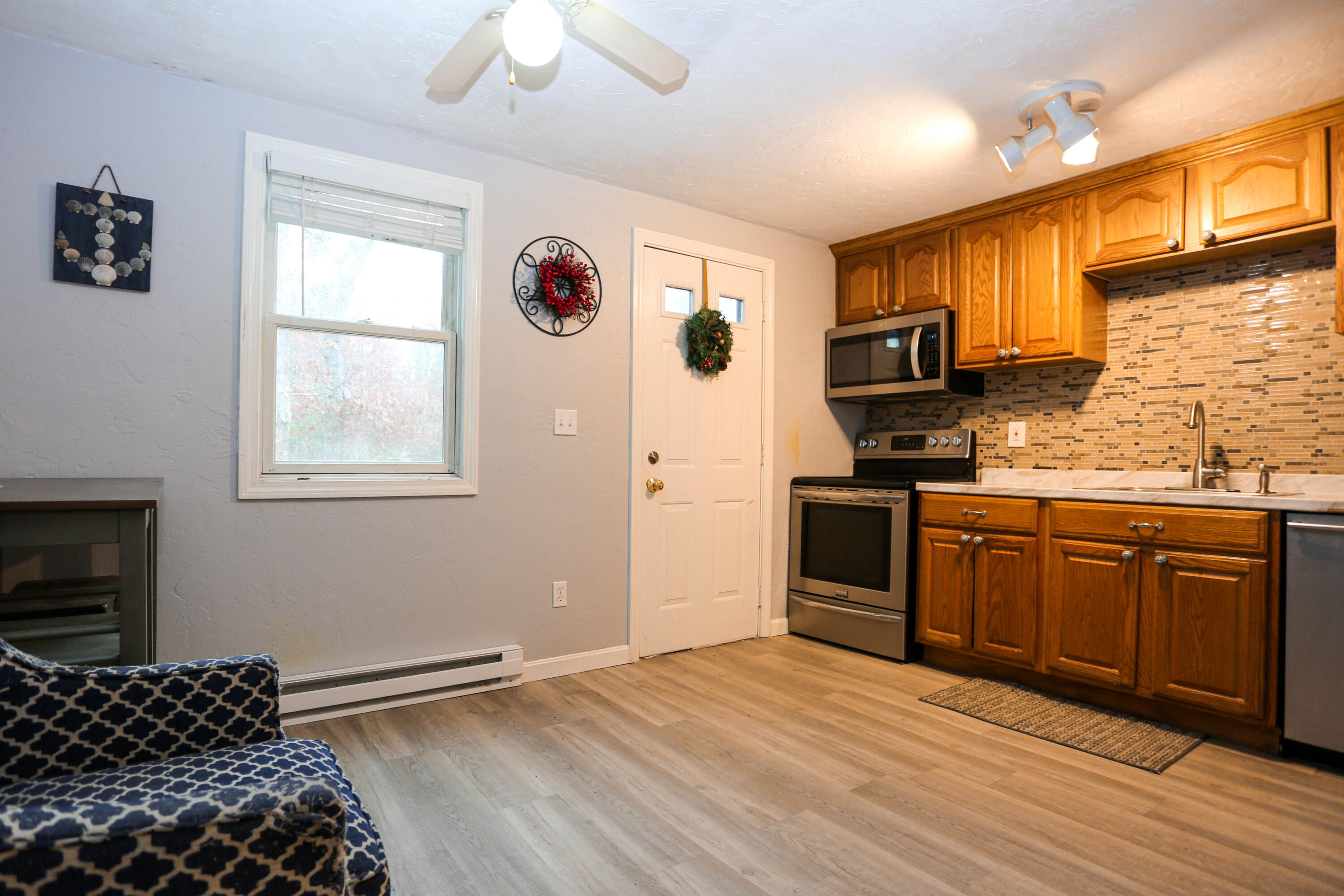 300 Falmouth Road, Unit 2C Mashpee, MA 02649 - Photo 8 of 17 a kitchen with stainless steel appliances granite countertop a stove a sink and a refrigerator