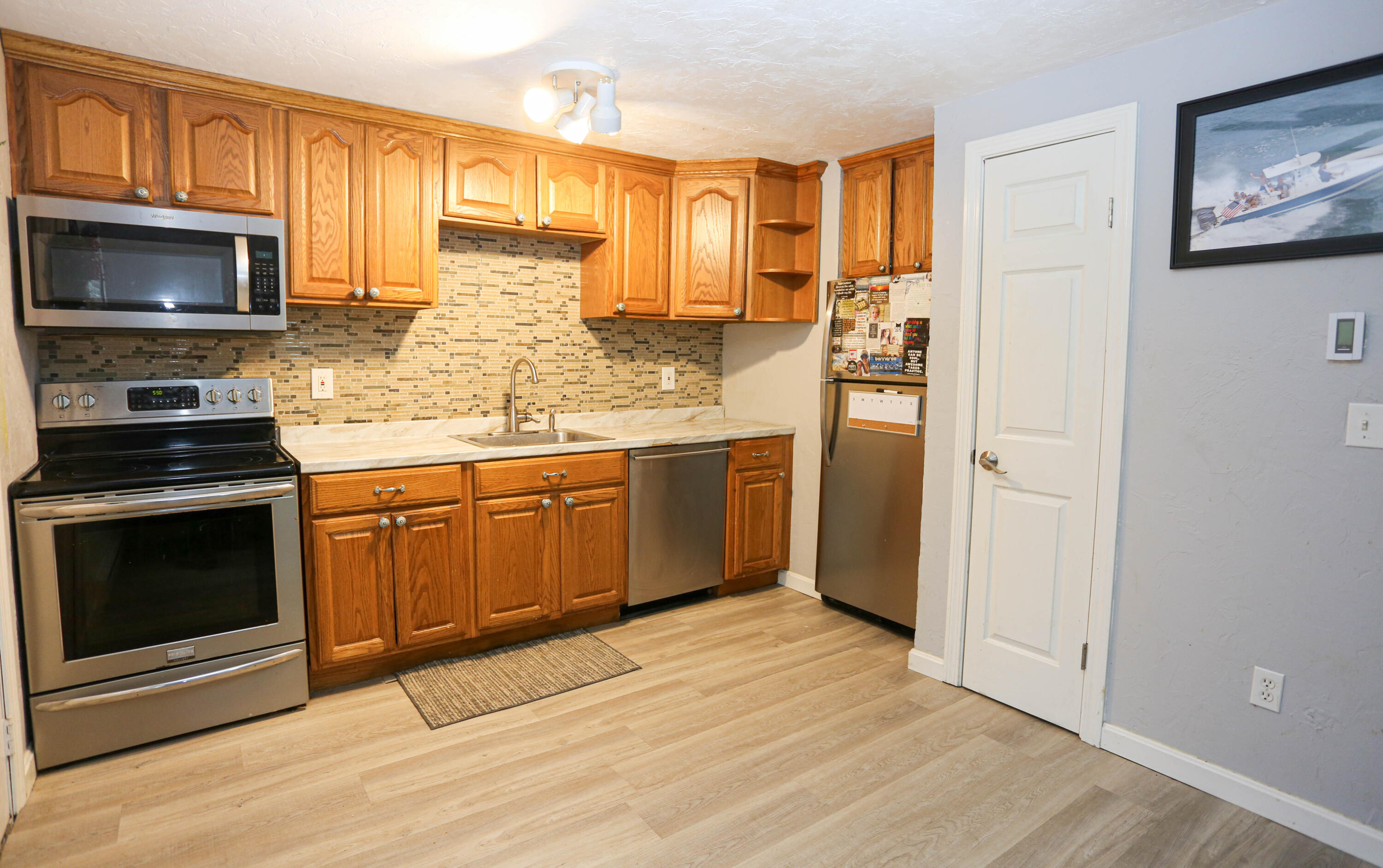 300 Falmouth Road, Unit 2C Mashpee, MA 02649 - Photo 9 of 17 a kitchen with stainless steel appliances granite countertop a stove microwave and refrigerator