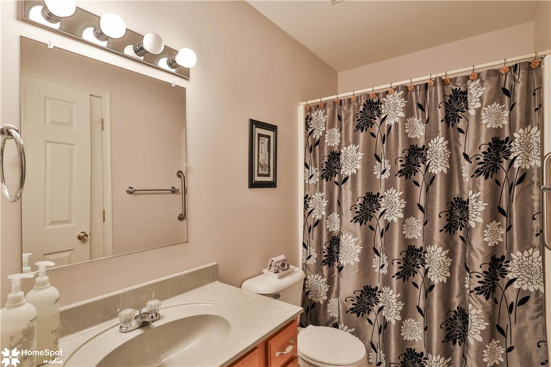 507 Howertown Road Northampton, PA 18067 - Photo 26 of 46 A well-lit bathroom with a clean vanity, bright mirror, and floral shower curtain.