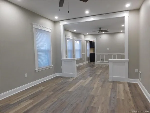 a view of a hallway with wooden floor