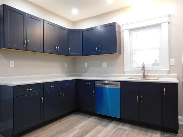 a kitchen with wooden cabinets