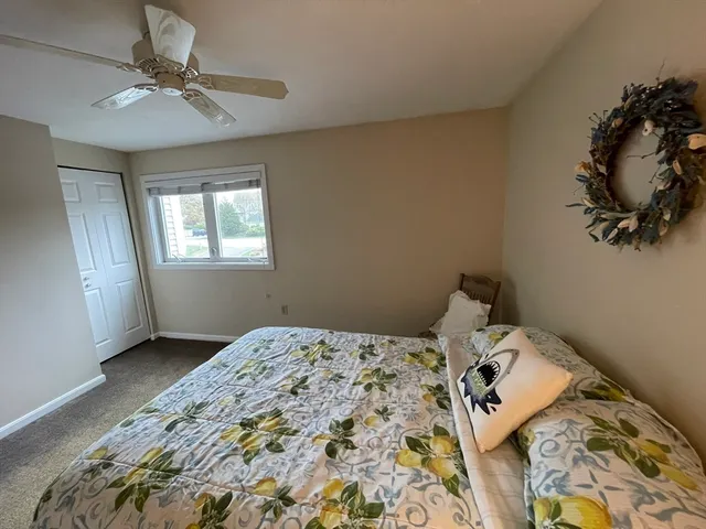 a bed sitting in a bedroom next to a window