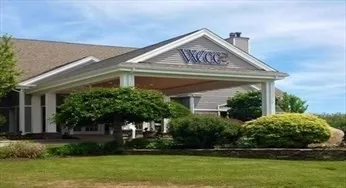 a front view of a house with a yard table and chairs