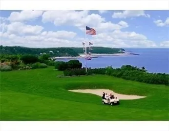 a view of a house next to a yard and sitting area