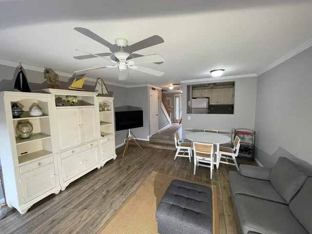 a living room with furniture a flat screen tv and a table