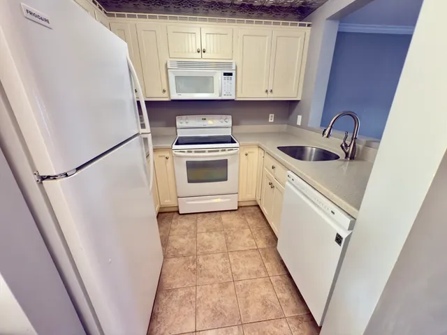 a kitchen with a sink a stove and cabinets