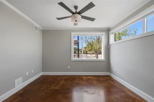 a view of room with window and ceiling fan