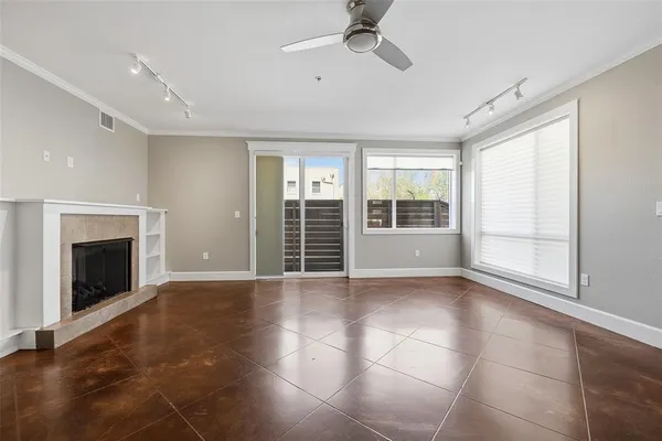 a view of an empty room with a fireplace and a window