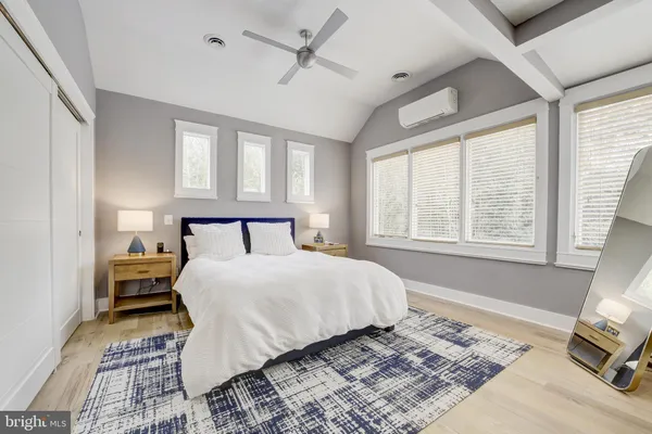 a bedroom with a large bed and a window