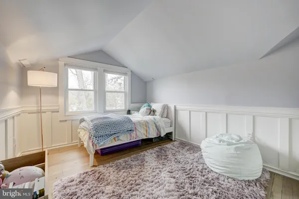 a spacious bedroom with a bed and a window
