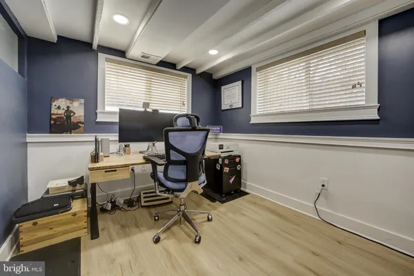 a view of a workspace with furniture and a window