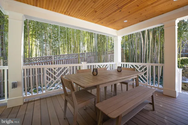 a outdoor dining space with furniture and wooden floor