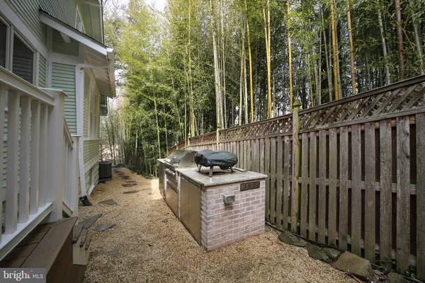 a view of a backyard with chairs and a stove