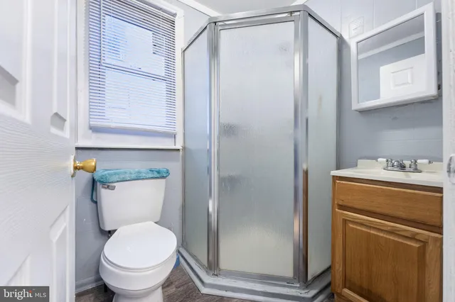 a bathroom with a toilet and a shower
