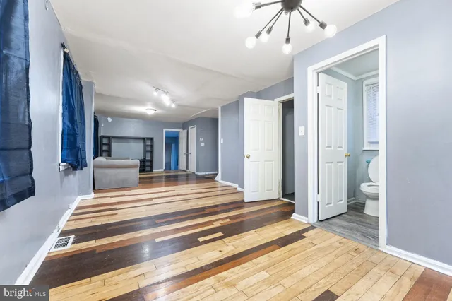a spacious bedroom with a bed and a view of bathroom