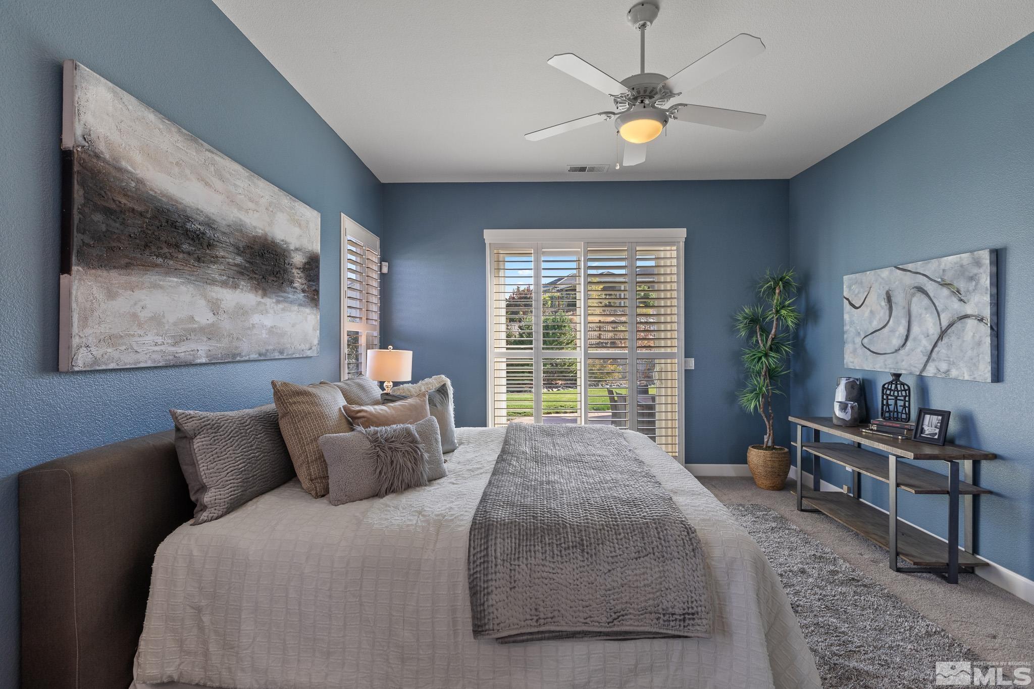 2040 North Tesuque Road Reno, NV 89511 - Photo 23 of 40 a bedroom with a bed and a chandelier