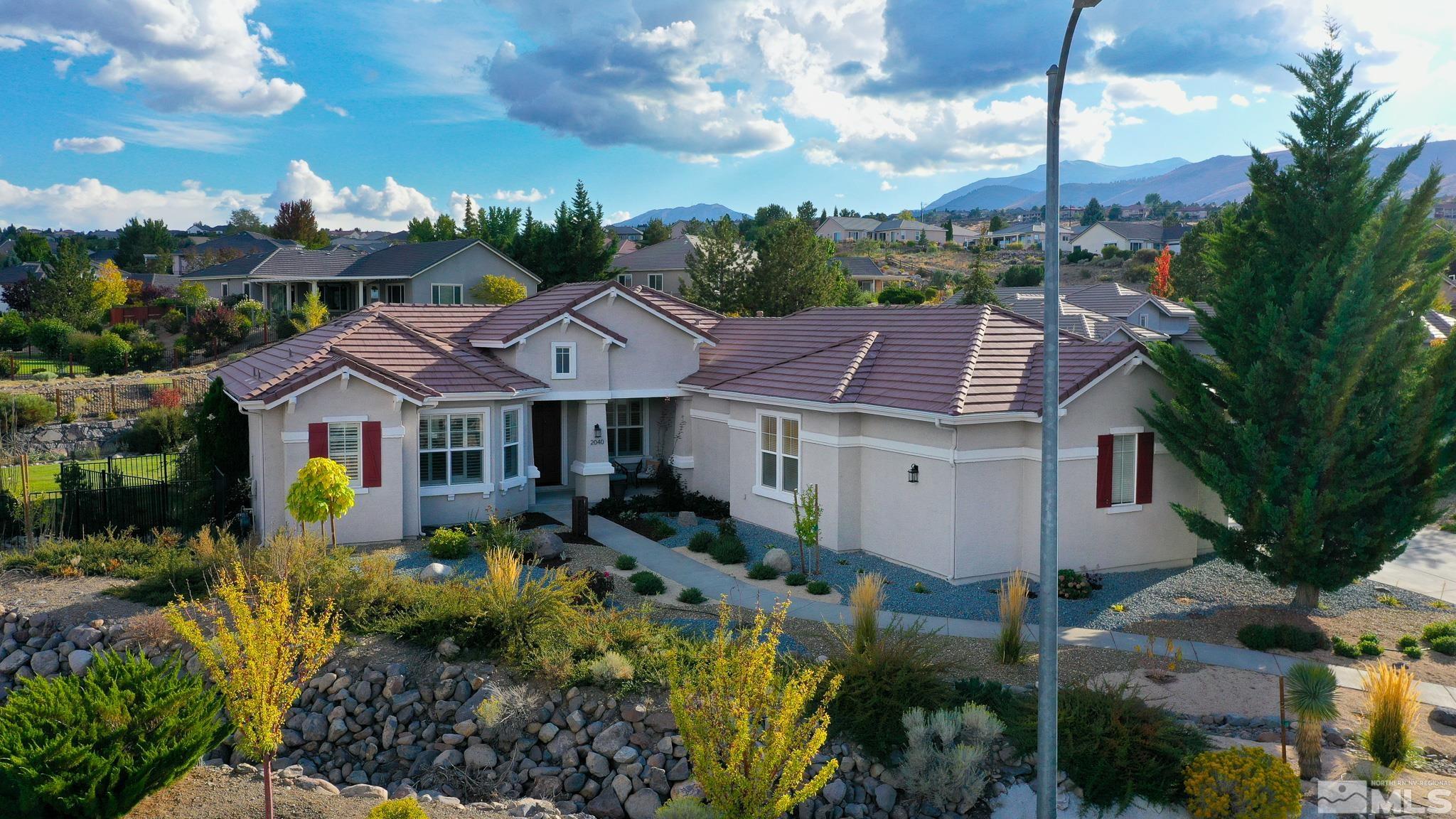 2040 North Tesuque Road Reno, NV 89511 - Photo 3 of 40 a front view of a house with a garden