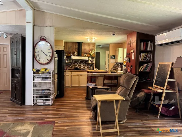 a living room with furniture a rug and a clock