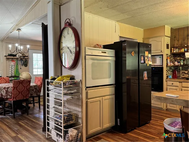 a kitchen with stainless steel appliances a refrigerator and a stove