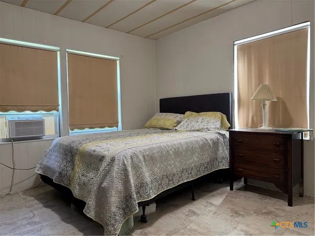 a bedroom with a bed and window