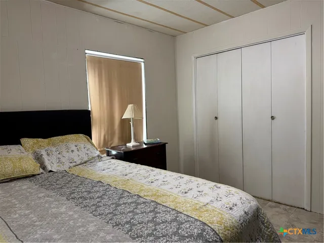 a bedroom with a bed and a mirror