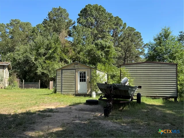 a view of a yard with a tree