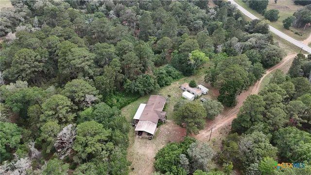an aerial view of a house with a yard
