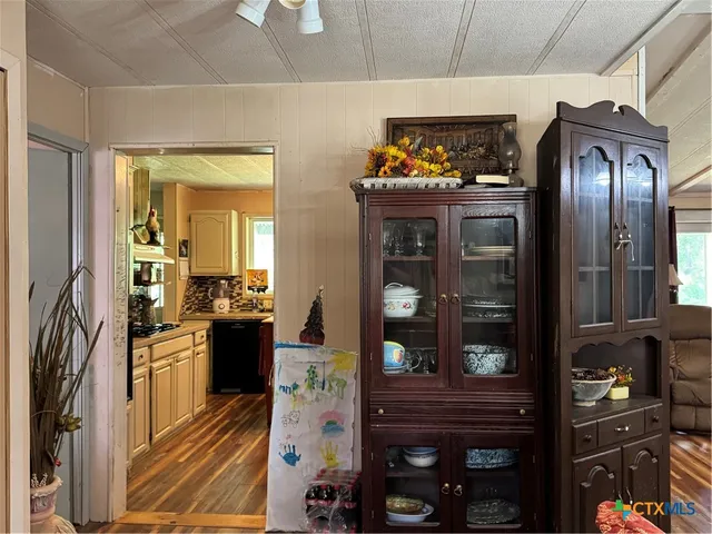 a kitchen with granite countertop stainless steel appliances and wooden floor