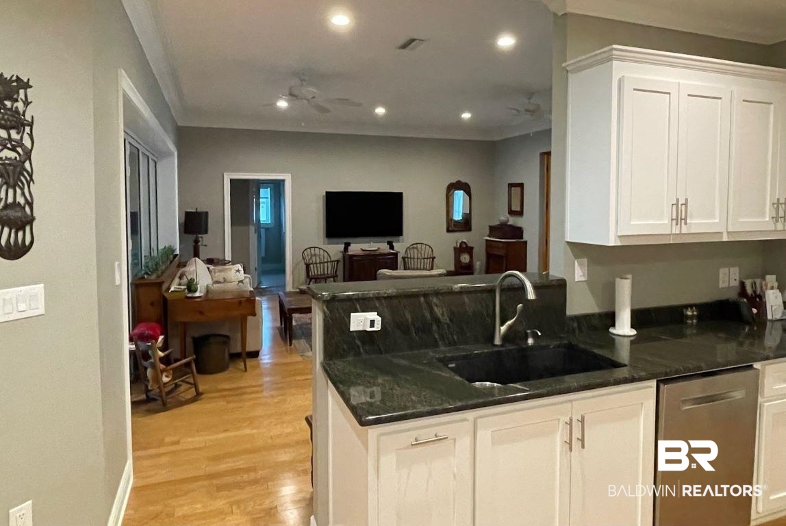 6426 East Quarry Drive Elberta, AL 36530 - Photo 7 of 19 Kitchen with white cabinetry, ceiling fan, sink, dishwasher, and light hardwood / wood-style flooring