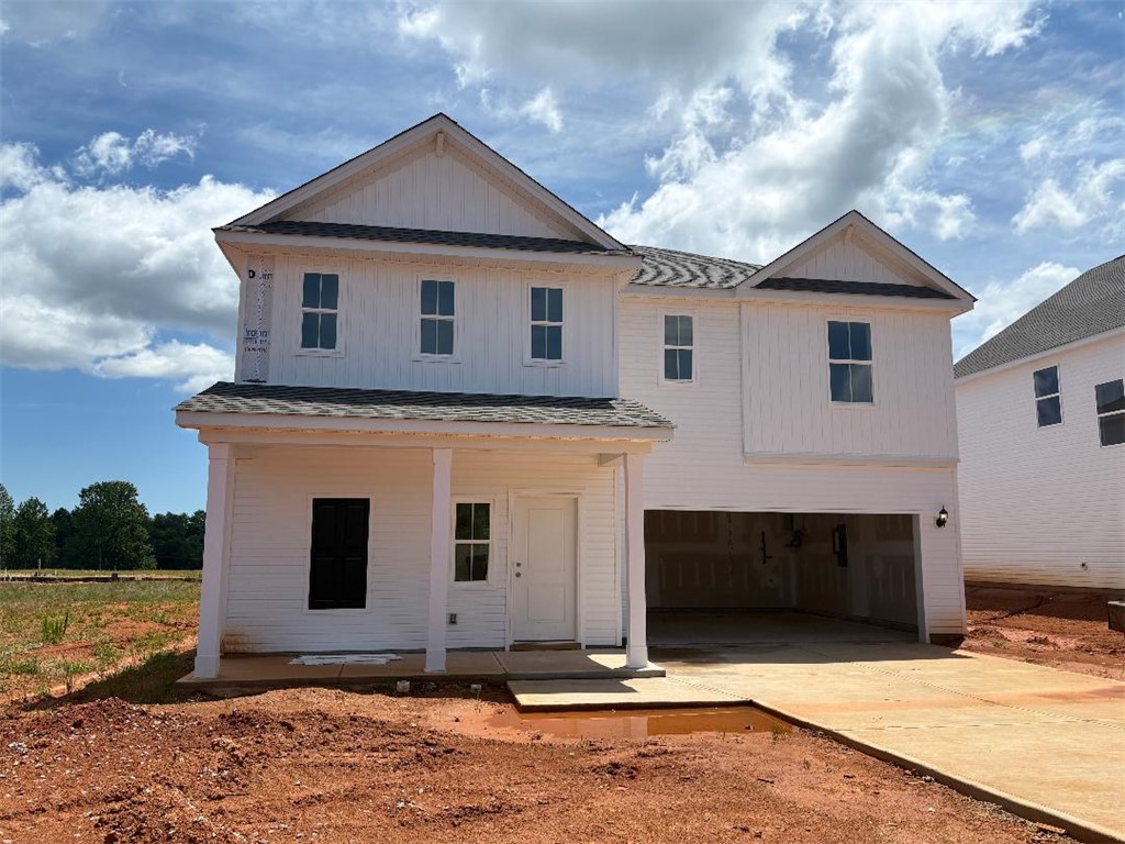 129 Cedar Shoals Easley, SC 29640 - Photo 1 of 31 A newly constructed residence showcasing a welcoming front porch and an integrated garage entrance.