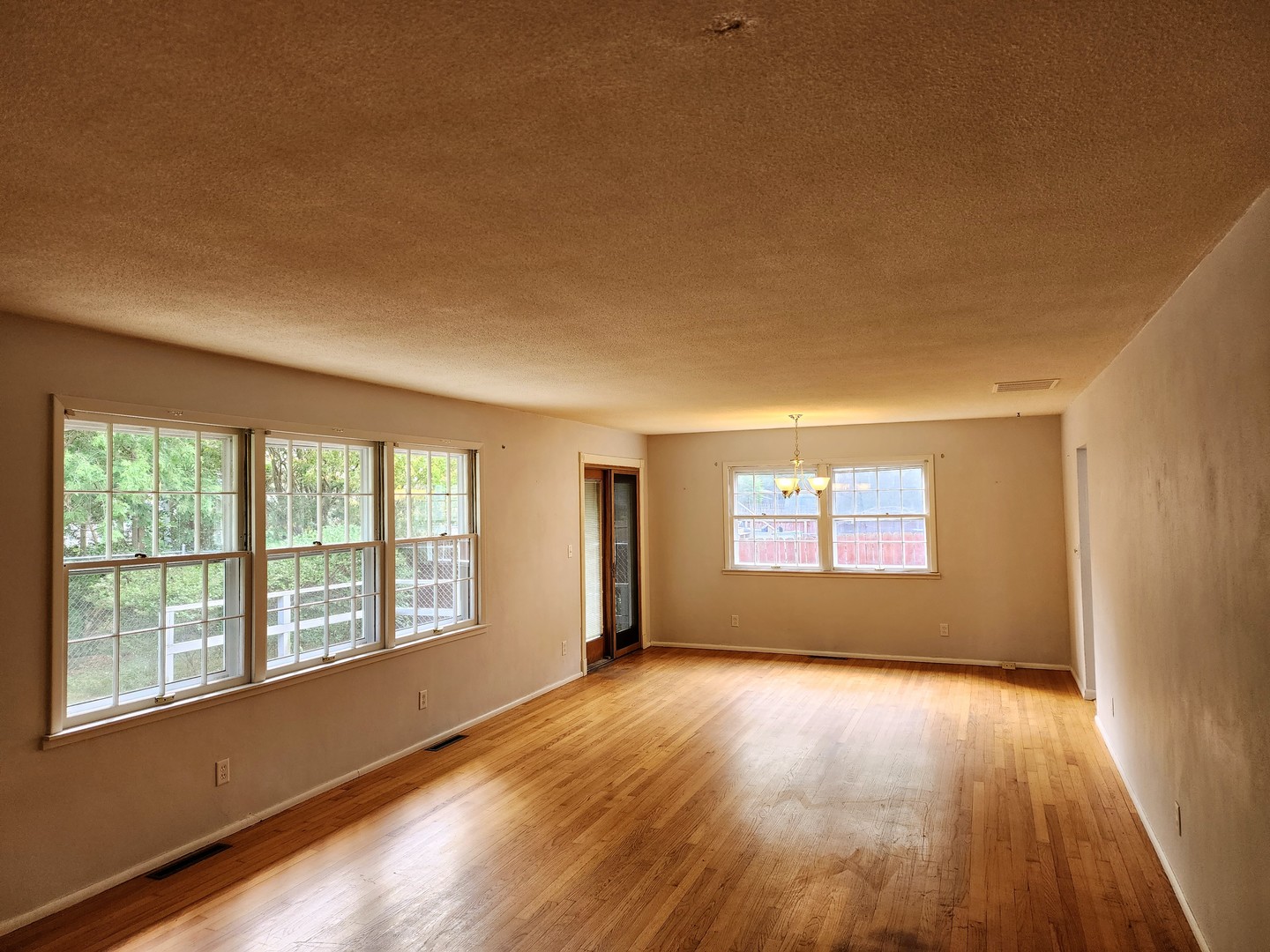 1825 Crescent Drive Champaign, IL 61821 - Photo 4 of 24 a view of an empty room with wooden floor and a window