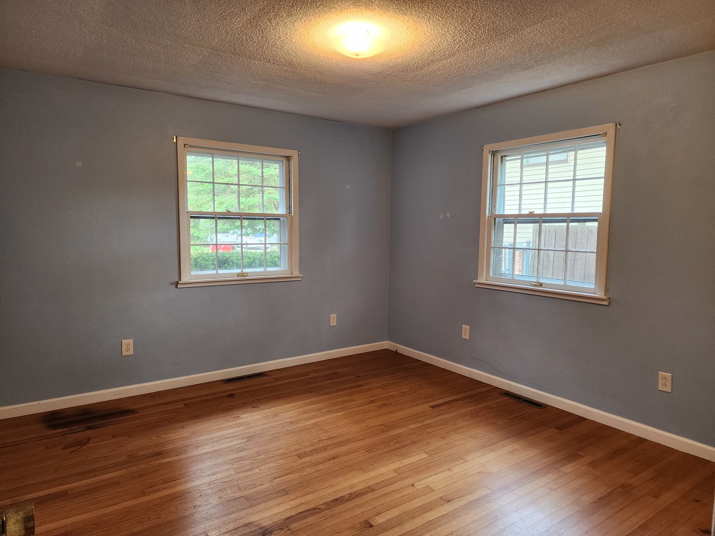 1825 Crescent Drive Champaign, IL 61821 - Photo 7 of 24 a view of a room with wooden floor and windows