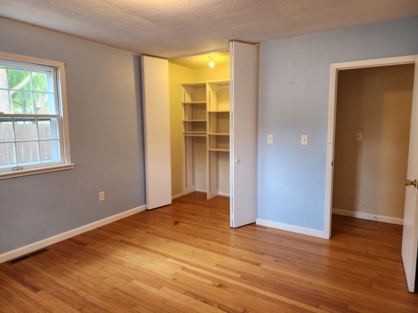 1825 Crescent Drive Champaign, IL 61821 - Photo 8 of 24 a view of an empty room with wooden floor and a window