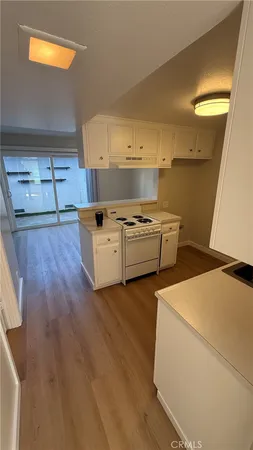 a kitchen with stainless steel appliances granite countertop a sink and a stove