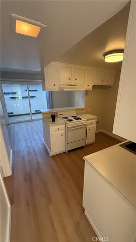 a kitchen with stainless steel appliances granite countertop a sink and a stove