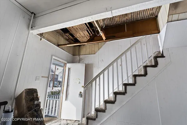 a view of staircase with white walls