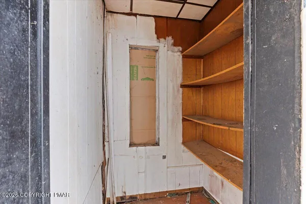 a view of a kitchen with fridge and wooden floor