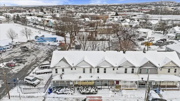 an aerial view of a residential apartment building and parking space