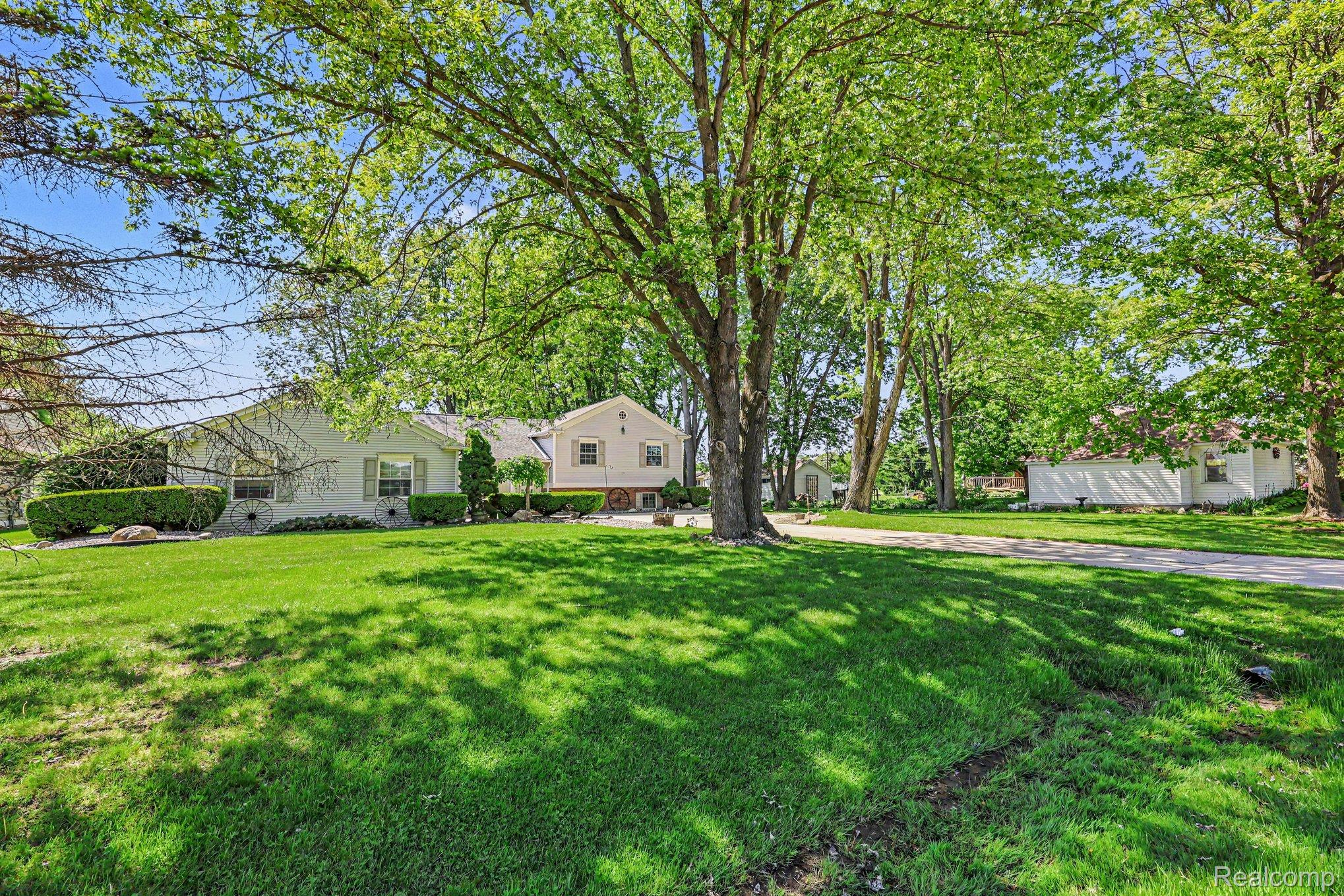 7020 Meldrum Road Fair Haven, MI 48023 - Photo 31 of 43 Expansive front lawn with mature trees providing dappled shade