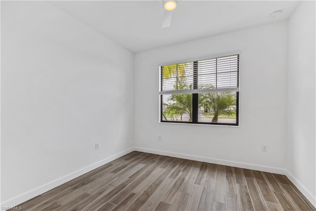 1817 Lema Court Naples, FL 34120 - Photo 16 of 22 a view of an empty room with wooden floor and a window