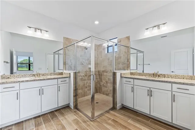 a bathroom with a granite countertop sink mirror and double