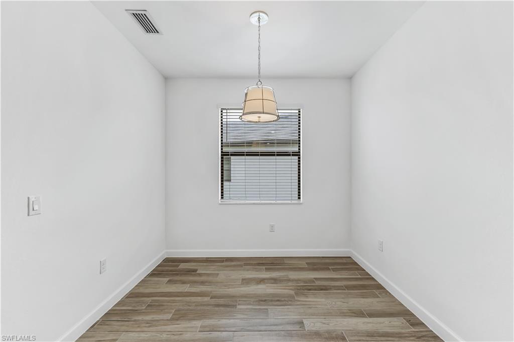1817 Lema Court Naples, FL 34120 - Photo 20 of 22 a view of a room with wooden floor wooden floor and windows