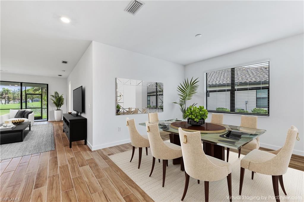 1817 Lema Court Naples, FL 34120 - Photo 6 of 22 a view of a dining room with furniture and wooden floor