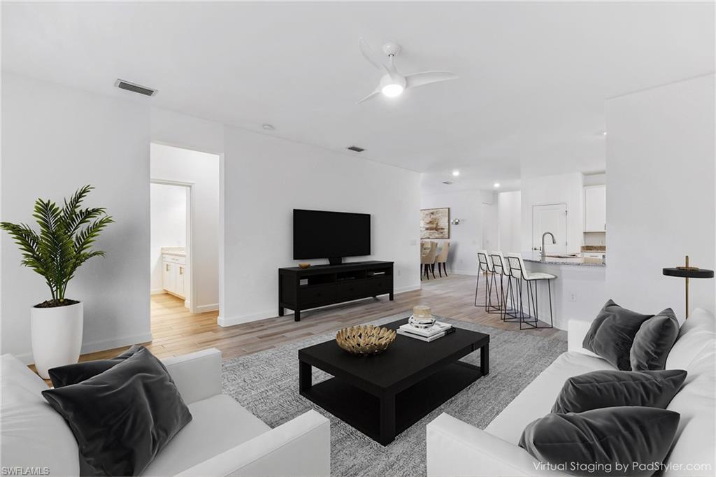 1817 Lema Court Naples, FL 34120 - Photo 9 of 22 a living room with furniture and a flat screen tv